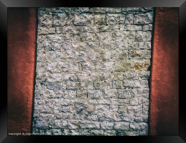 Crooked and abstract old brick wall between red concrete Framed Print by Ingo Menhard