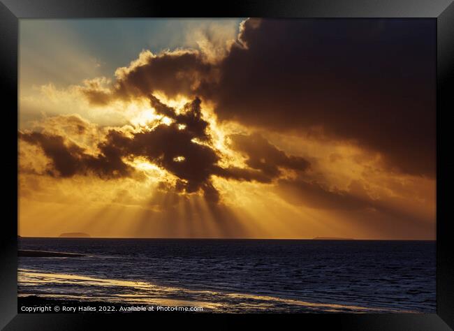 Crepuscular rays breaking through the cloud cover Framed Print by Rory Hailes