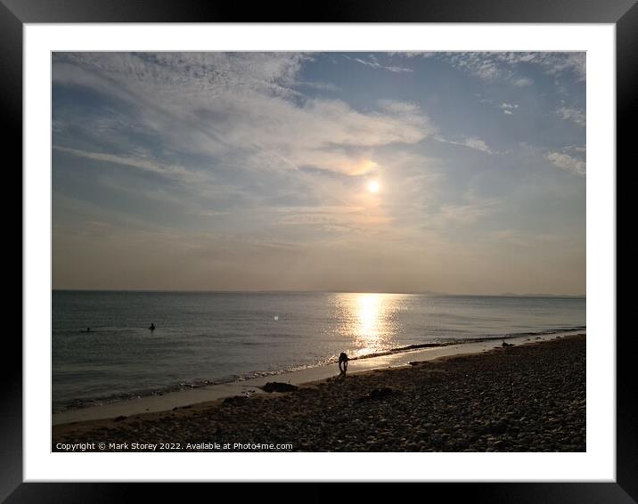 A sunset over a beach next to the ocean Framed Mounted Print by Mark Storey