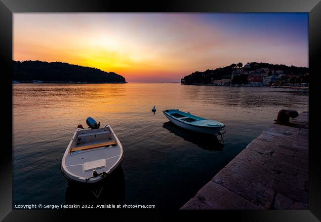 Fishing boats in a sea, near coast. Sunset time. Framed Print by Sergey Fedoskin