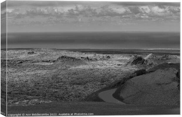 View to the sea over the volcanos in black and white Canvas Print by Ann Biddlecombe