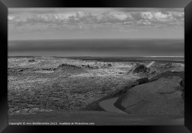 View to the sea over the volcanos in black and white Framed Print by Ann Biddlecombe