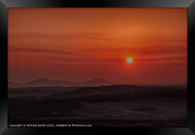 Sun setting through a low haze.  Framed Print by Richard Smith