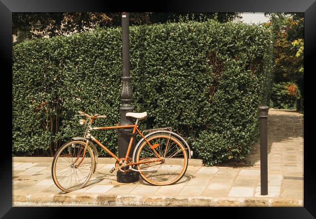 Old bicycle on the street  Framed Print by Veronika Druzhnieva