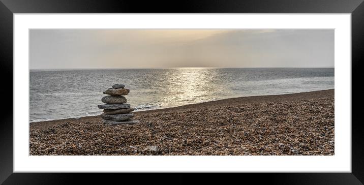 Tranquil beach with stone sculpture and sun on water - Dorset Framed Mounted Print by Gordon Dixon
