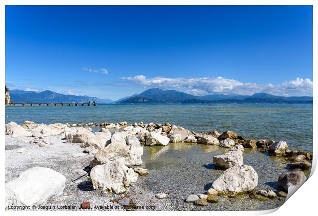 Calm water lake in Garda, Italy with a wooden walkway on a sunny Print by Joaquin Corbalan