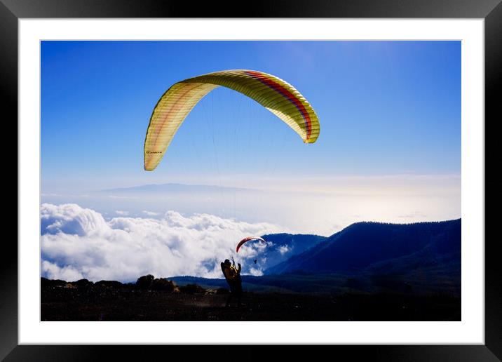 Skydiving experts and monitors prepare the sail of a paraglider  Framed Mounted Print by Joaquin Corbalan