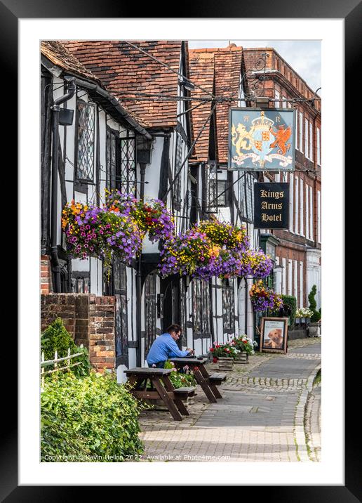 A man sits outside the Kings Arms Hotel in Amersham old town Framed Mounted Print by Kevin Hellon