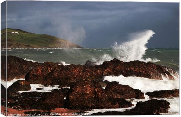 Sea spray and waves on the Antrim coast. Canvas Print by Paul Clifton