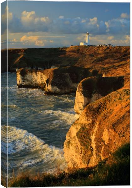 Flamborough lighthouse and cliffs at sunrise. Canvas Print by Drew Watson