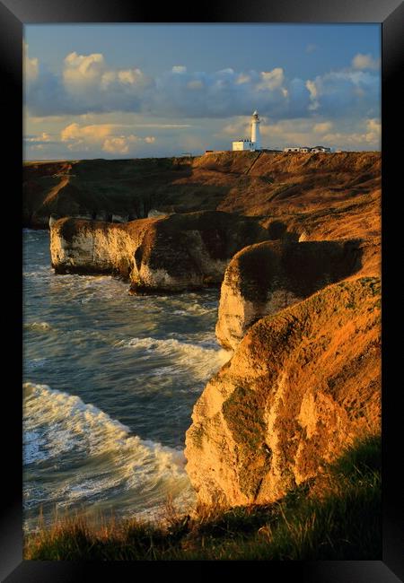 Flamborough lighthouse and cliffs at sunrise. Framed Print by Drew Watson