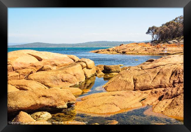 Red rocks and blue water - Coles Bay Framed Print by Laszlo Konya