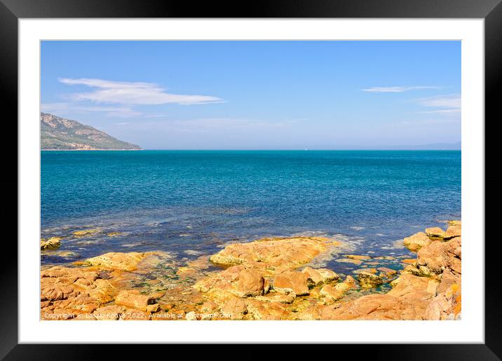 Red rocks and blue water - Coles Bay Framed Mounted Print by Laszlo Konya