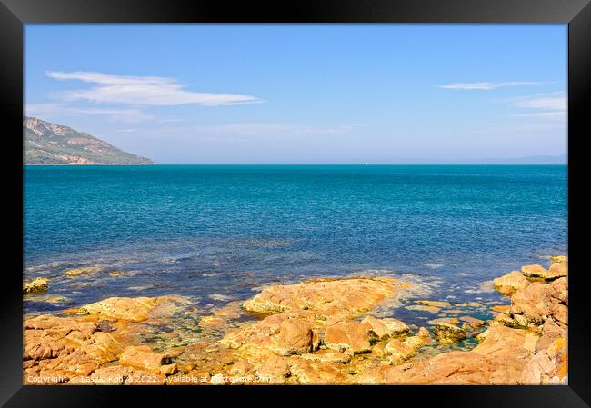 Red rocks and blue water - Coles Bay Framed Print by Laszlo Konya