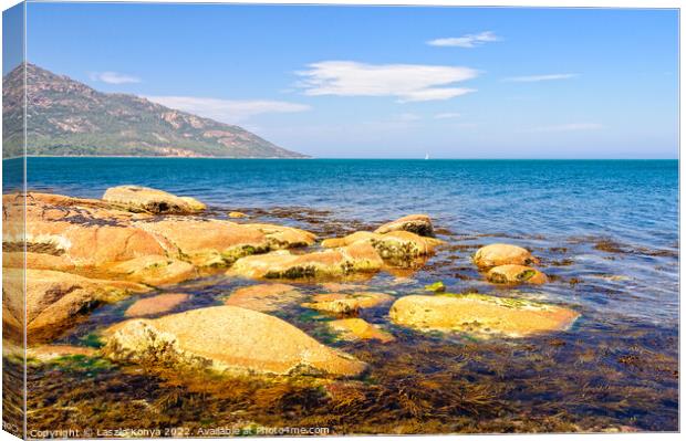 Red rocks and blue water - Coles Bay Canvas Print by Laszlo Konya