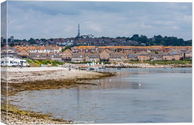 Chisel Beach Dorset reflection of the town in the water  Canvas Print by Holly Burgess