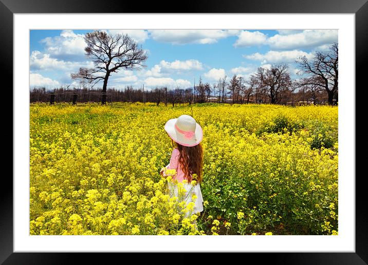 A small girl in a field of spring wildflowers Framed Mounted Print by Constantinos Iliopoulos