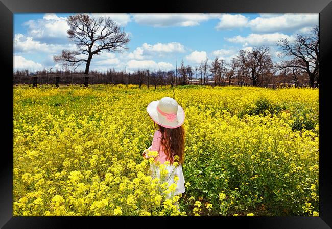 A small girl in a field of spring wildflowers Framed Print by Constantinos Iliopoulos
