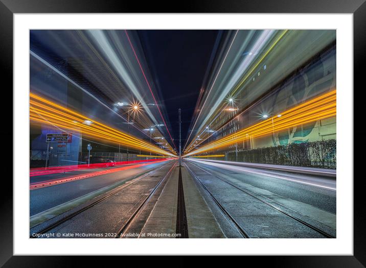 Passing light trails from 2 trams in Manchester Framed Mounted Print by Katie McGuinness
