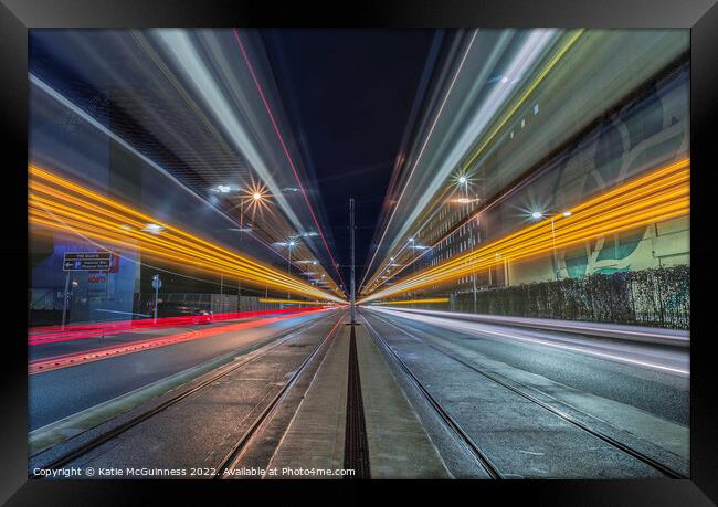 Passing light trails from 2 trams in Manchester Framed Print by Katie McGuinness