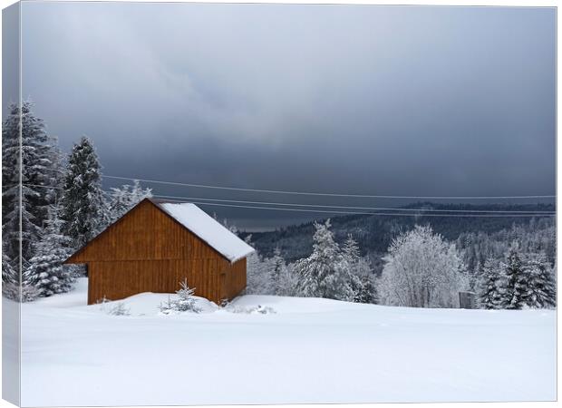 Winter calm mountain landscape with red shed or barn and mount ridge behind polish mountain named turbacz in Poland Canvas Print by Arpan Bhatia