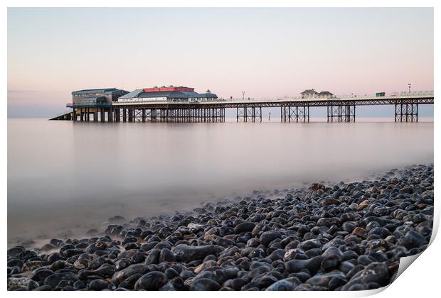 Cromer pier seen over the pebble beach Print by Jason Wells