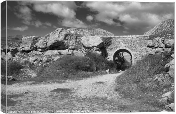 Stone archway at Portland Quarry in black and white Canvas Print by Ann Biddlecombe