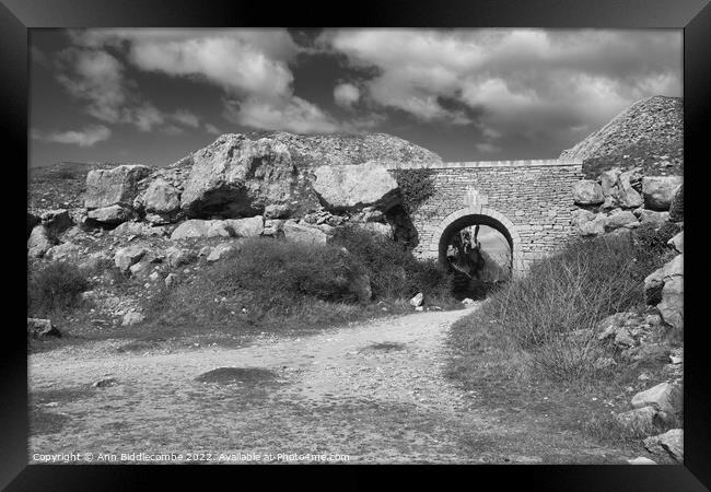 Stone archway at Portland Quarry in black and white Framed Print by Ann Biddlecombe