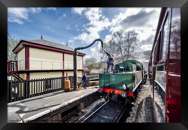Taking on water at Keighley station. Framed Print by Chris North