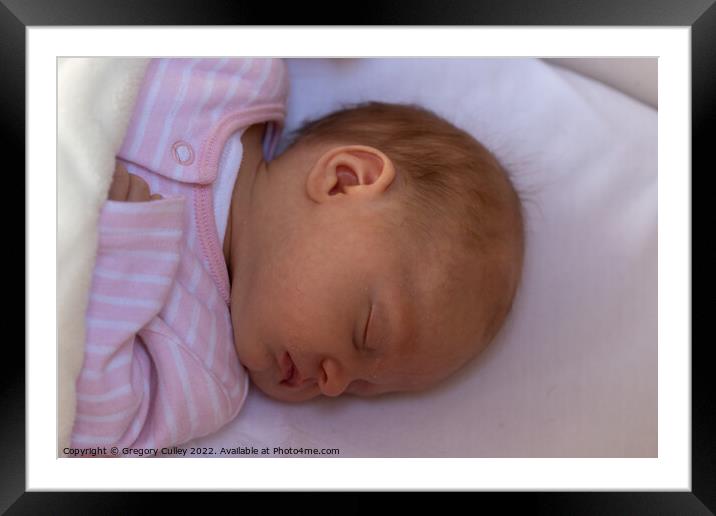 Sleeping newborn baby girl wearing a pink sleepsui Framed Mounted Print by Gregory Culley