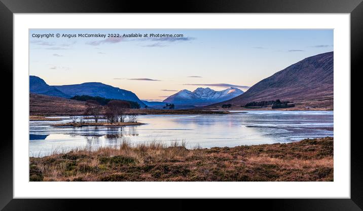 An Teallach viewed across frozen Loch Droma Framed Mounted Print by Angus McComiskey