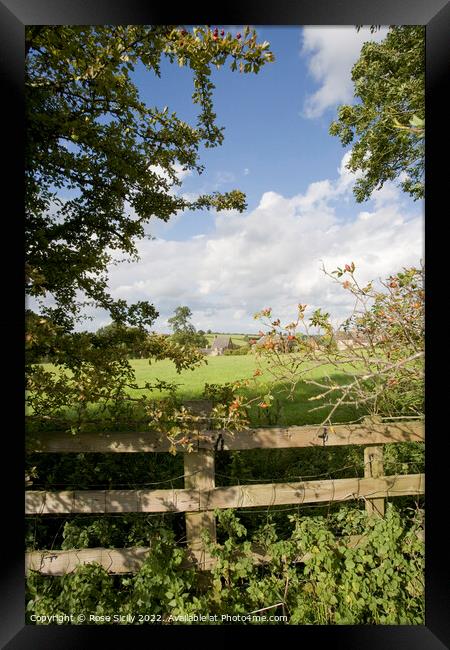 Looking over fence towards Oxfordshire village Framed Print by Rose Sicily
