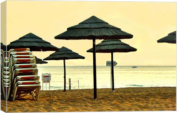 Sun set umbrellas on the beach in Portgual Canvas Print by Tanya Hodgkiss