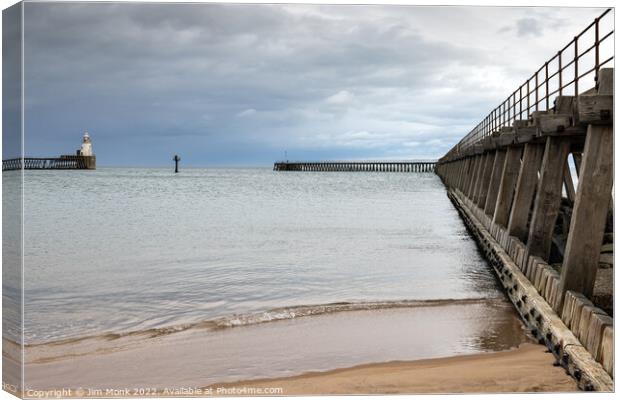 Blyth Piers and Lighthouse Canvas Print by Jim Monk