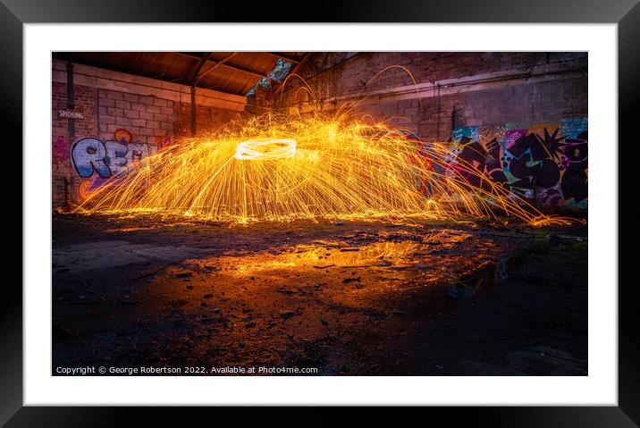 Showers of hot glowing sparks from spinning steel  Framed Mounted Print by George Robertson