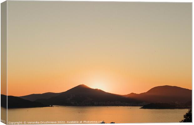 A sunset over a body of water, Montenegro  Canvas Print by Veronika Druzhnieva