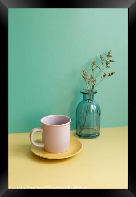 Coffee cup and dry flower Framed Print by Sanga Park