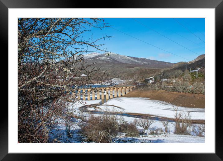 railroad bridge across the snowy valley Framed Mounted Print by David Galindo