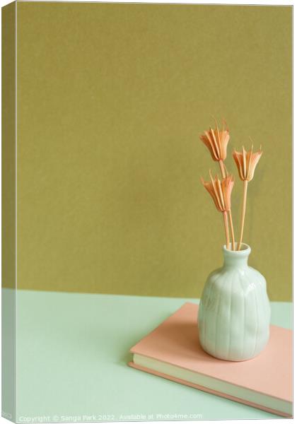 Notebook and vase of dry flower Canvas Print by Sanga Park