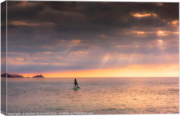 The setting sun over a lone paddle boarder at Fist Canvas Print by Gordon Scammell
