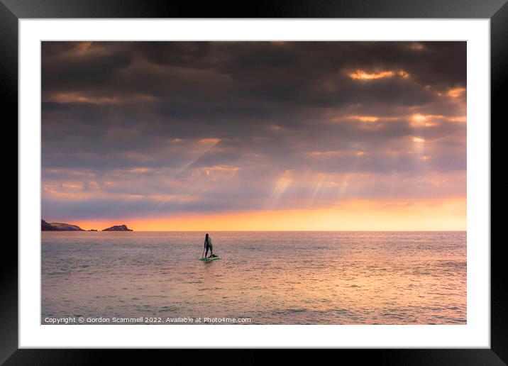 The setting sun over a lone paddle boarder at Fist Framed Mounted Print by Gordon Scammell