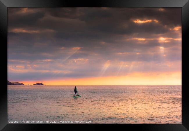 The setting sun over a lone paddle boarder at Fist Framed Print by Gordon Scammell