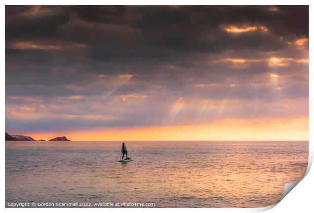 The setting sun over a lone paddle boarder at Fist Print by Gordon Scammell
