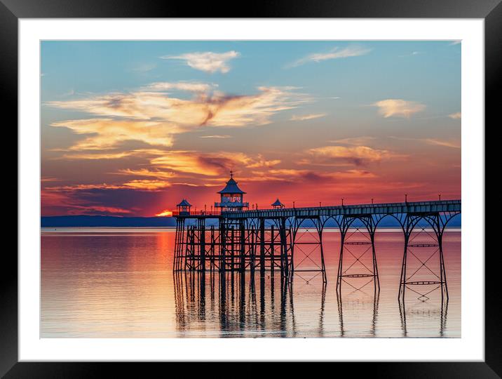 Clevedon Pier at sunset with colourful reflection on the sea Framed Mounted Print by Rory Hailes