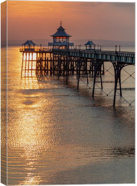Clevedon Pier with a golden reflection on the sea Canvas Print by Rory Hailes