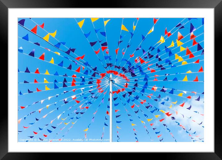Colourful bunting against a blue sky. Framed Mounted Print by Gordon Scammell