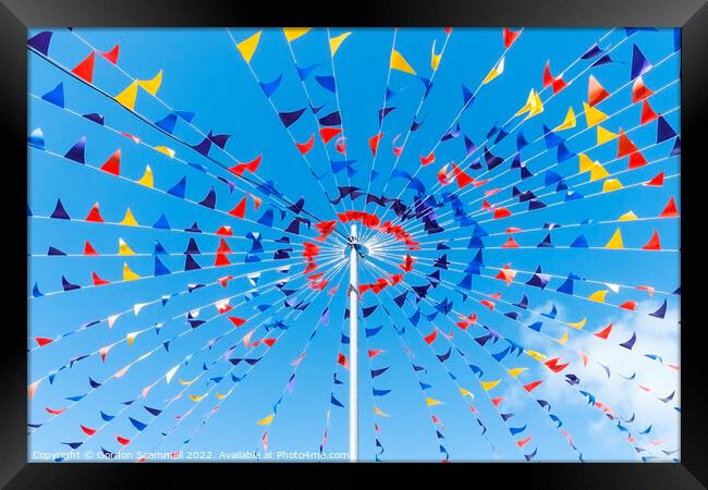 Colourful bunting against a blue sky. Framed Print by Gordon Scammell