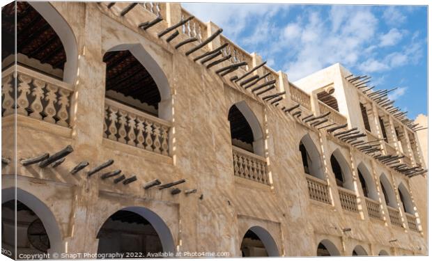 Middle eastern architecture with bamboo wooden poles sticking out of a building Canvas Print by SnapT Photography