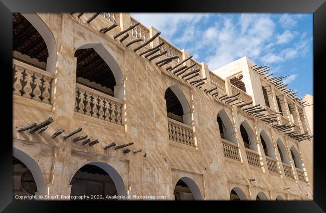 Middle eastern architecture with bamboo wooden poles sticking out of a building Framed Print by SnapT Photography