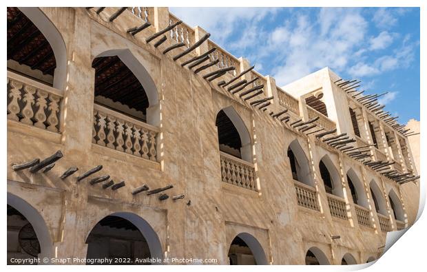 Middle eastern architecture with bamboo wooden poles sticking out of a building Print by SnapT Photography